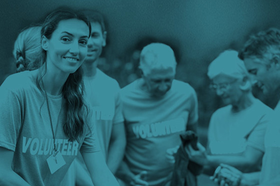 A group of people wearing t-shirts with the word "volunteer" on them
