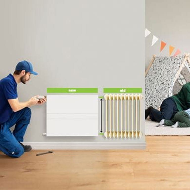 Installer installing a new radiator next to an old one