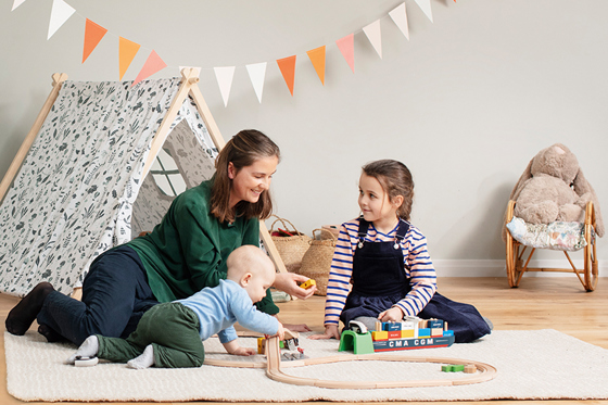 Mother playing with her children in an indoor climate solution